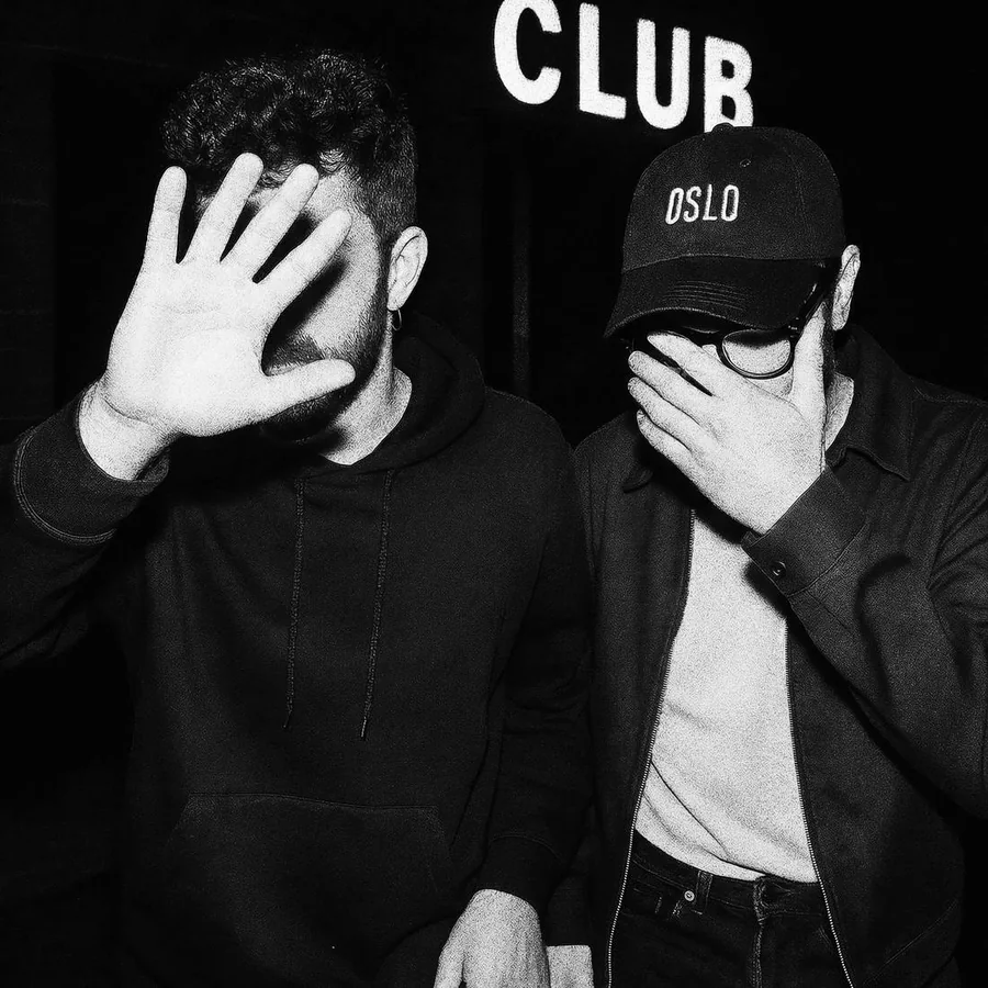 Nacho Herran and Jaime Max, covering their faces